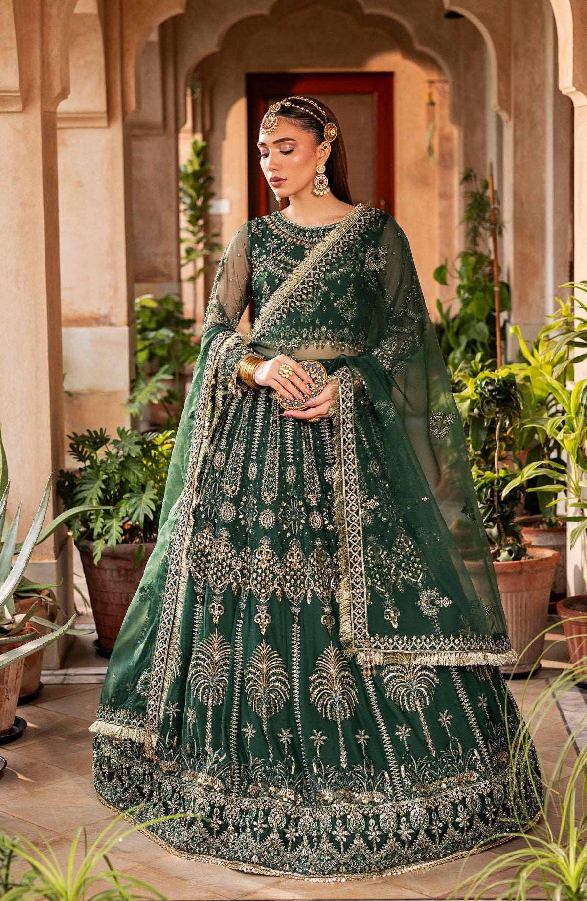 Model wearing Aylin emerald maxi dress styled for evening occasions